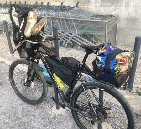 Loading-food-into-basket-of-bike